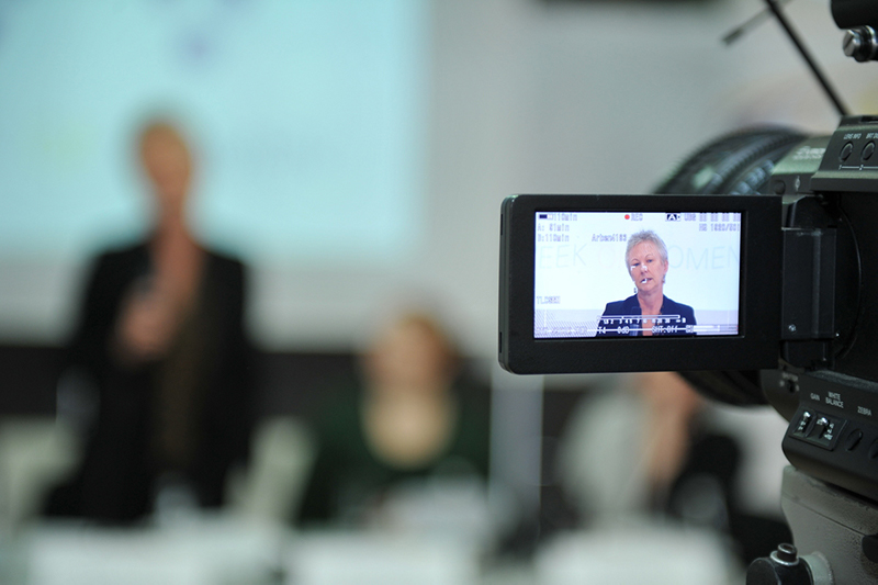 Camera recording a woman speak 